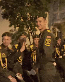 a group of soldiers are standing in a line and one of them has the number 1 on his uniform