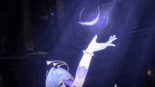 a girl is holding a purple feather in her hand in a dark room .