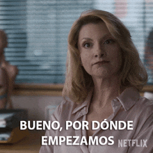 a woman is sitting in front of a window and says bueno por donde empezamos