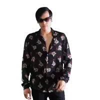 a man wearing a black shirt with flowers on it is standing in front of a white background
