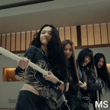 a group of women are pulling a rope and the letters ms are on the bottom