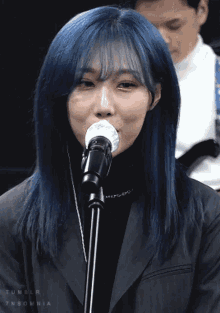 a woman with blue hair singing into a microphone with tumblr insomnia written on the bottom
