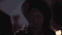 a blurred image of a person 's face with a hat on