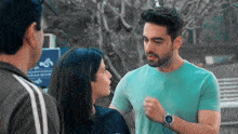a man and a woman are talking to each other while standing next to each other .