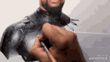 a person is drawing a man 's torso with a pen and the words made in animotica on the bottom