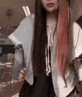 a girl with long hair is wearing a white jacket and a black skirt