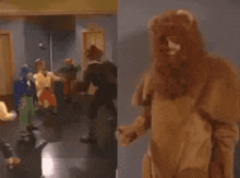 a man in a lion costume is standing in front of a group of people dancing .