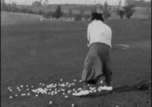 a man is hitting golf balls on a golf course .