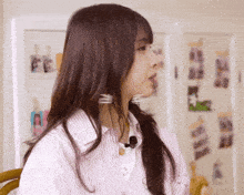 a woman with long hair is wearing a pink shirt