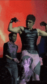 a man is flexing his muscles in front of a red background and the word keith is on the bottom right