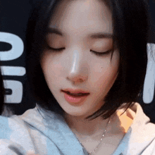 a close up of a woman 's face with her eyes closed and her mouth open .