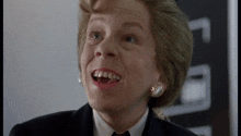 a close up of a woman 's face with her mouth open