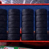 several tires are stacked on top of each other on a shelf that says team regular