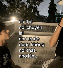 a man smoking a cigarette next to a sign that says có thể nói chuyện