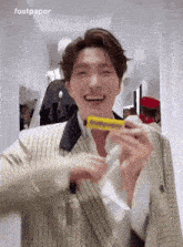 a man in a suit is holding a fastpaper bar in his hands