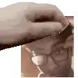 a close up of a person 's head with a hand on it .