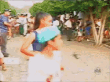 a blurry picture of a woman carrying a child