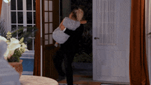 a man is holding a woman in his arms in a room