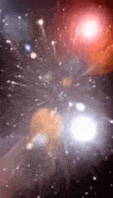 a blurred image of a fireworks display in a dark night sky