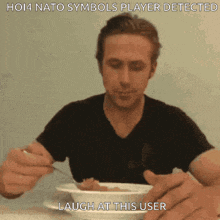 a man in a black shirt is eating a bowl of food with a caption that says ho14 nato symbols player detected