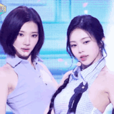 two women are standing next to each other in front of a sign that says ' sbs ' on it