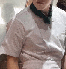 a man wearing a white shirt and a green tie