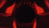 a close up of a person 's hand holding a red object in a dark room .