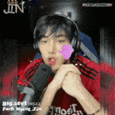 a man wearing headphones and a red shirt that says t98 on it