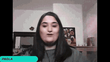 a woman in a video call with the name paola on the screen