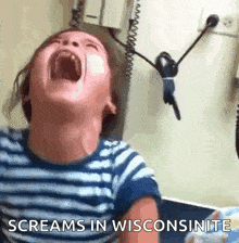 a child is screaming in wisconsinite with his mouth open