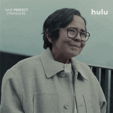 an advertisement for nine perfect strangers shows a woman with glasses and the words of course