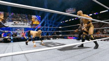 two wrestlers in a ring with a sign that says world heavyweight championship on it