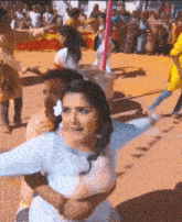 a woman in a white dress is being held by a man