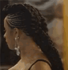 a woman wearing earrings and a braided hairstyle is talking about forever .