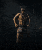 a man without a shirt is wearing a native american outfit