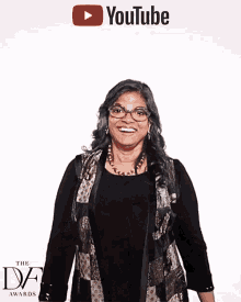a woman stands in front of a youtube banner