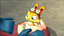 a cartoon rabbit wearing goggles is laying on a person 's shoulder