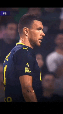 a soccer player wearing a blue and yellow jersey that says safirport