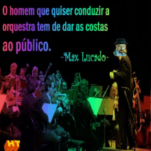 an orchestra is playing in front of a sign that says max lucado