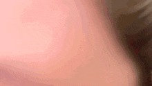a close up of a pink and brown background with a blurred image .