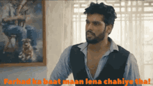 a man with a beard is standing in front of a painting with the words farhad ka baat maan lena chahiye tha