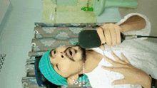 a man with a beard is singing into a microphone
