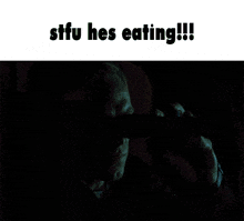 a man eating a pizza in a car with the words stfu hes eating
