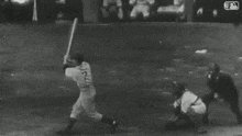 a black and white photo of a baseball game with the mlb logo on the bottom