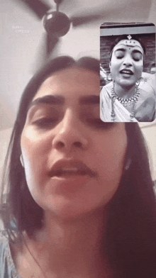 a woman with a crown on her head is talking to another woman on a video call