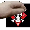 a hand is holding a piece of paper with a skull and crossbones on it