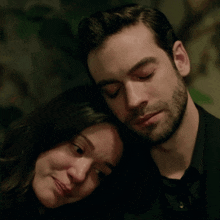 a man with a beard and a woman with tears in her eyes