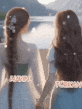 two women standing next to each other holding hands with the name havin and turkan written on the bottom