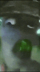 a blurred image of a person 's face with a green background