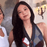 two women standing next to each other and one is wearing a plaid top